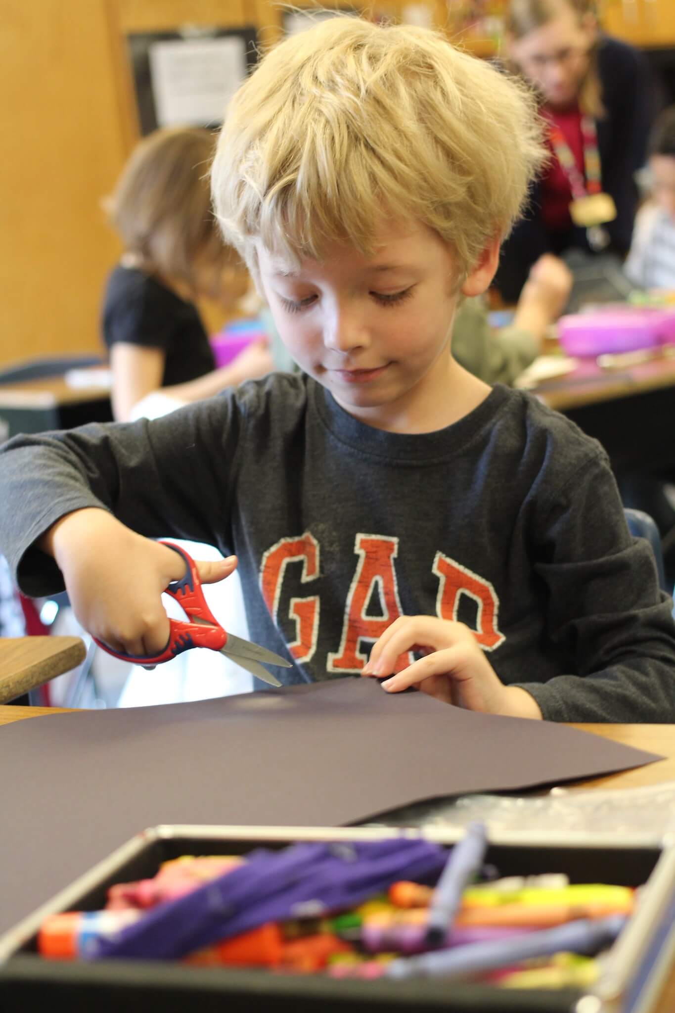 student-cutting-paper